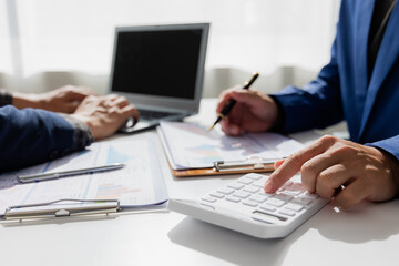 Close up of Asian male company executives working together reviewing business in the office