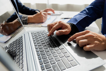 Close up of Asian male company executives working together reviewing business in the office