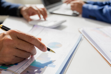 Close up of Asian male company executives working together reviewing business in the office