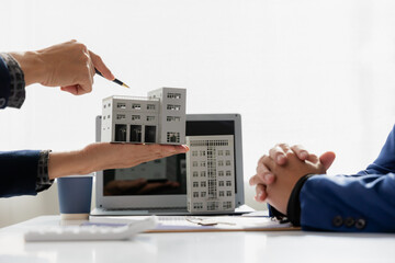 Cover image of a real estate agent auctioning off houses in the project to explain the details to clients. Explain and present information about buying a home and mortgages. Real estate trading concep