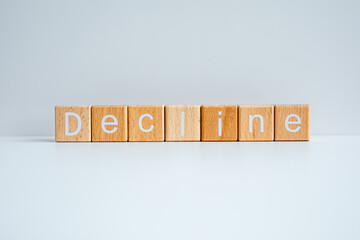 Wooden blocks form the text "Decline" against a white background.