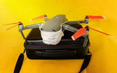 Drones forbidden concept: Unfolded drone covered by medical face mask. No fly zone