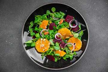 salad citrus tangerine, beet, green leaf lettuce, onion fresh eating meal food snack on the table copy space food background top view