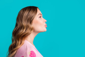 Side profile photo of young coquette girlfriend plump lips sending air kiss empty space learning flirt isolated on blue color background - obrazy, fototapety, plakaty