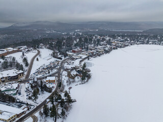 Fototapeta na wymiar Afternoon winter aerial photo of Mirror Lake in the Village of Lake Placid, New York. (01-05-2024)
