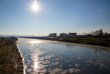 Landscape with ice floes floating on the water. Mures River in the city of Reghin in the spring