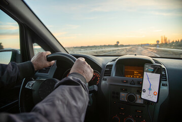 View of a driver looking at a straight road, driving with the help of a GPS