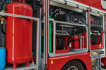 Close-up of essential firefighting equipment on a modern firetruck, showcasing tools and gear ready...