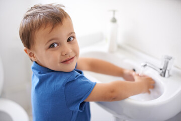 Child, boy and washing hands in portrait, water and prevention of germs or bacteria in bathroom....