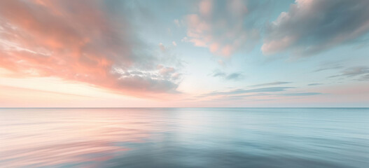 Tranquil seascape with pastel sunset clouds over calm water. Nature serenity.