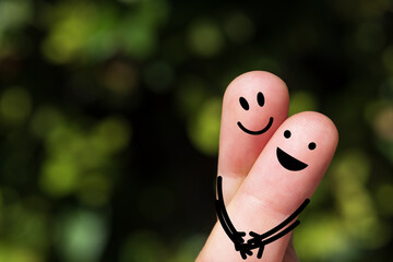 Happy finger, couple in love, Smile emoticon, Face emoticon on blurred park background.	