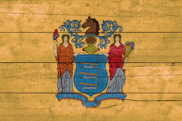 New Jersey State flag on a wooden surface. Banner of the grunge New Jersey State flag.