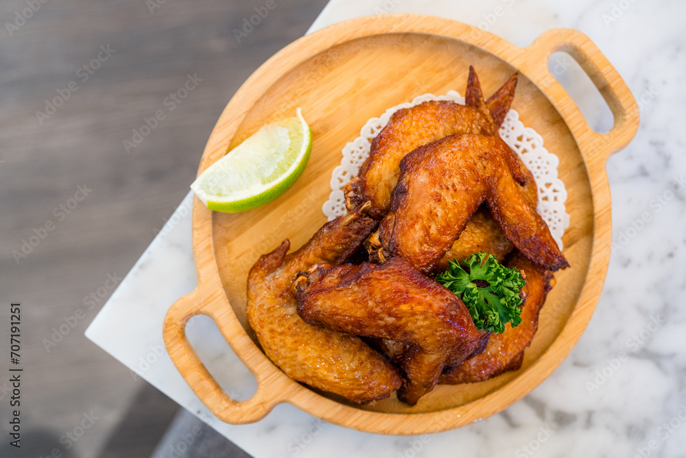 Canvas Prints Deep fried chicken wing on wooden plate