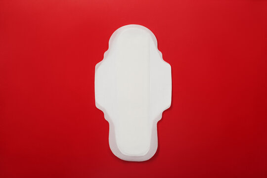 Women's menstrual pad on a red background