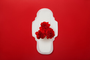 Menstrual pad with red carnations on red background