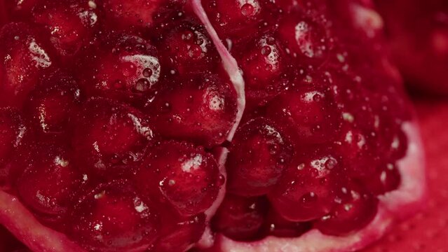 Red garnet close-up macro. Pomegranate fruit. Vitamins. Health food concept.Peeling garnets