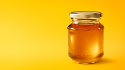 Honey pot isolated on empty yellow background - obrazy, fototapety, plakaty