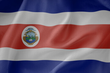 Costa rica state waving flag close up fabric texture background