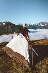 Man setting up tent camping gear climbing mountains travel healthy lifestyle outdoor traveler...