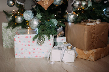 The photo depicts presents under a Christmas tree, surrounded by festive decorations 5467.