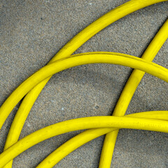 yellow hose on asphalt, from above, square type - obrazy, fototapety, plakaty