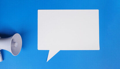  Speech bubble and megaphone on blue background.