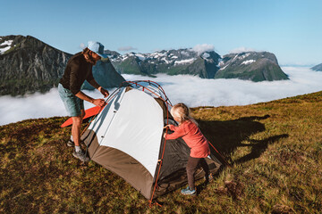 Family setting up tent camping gear in mountains father and child hiking together active travel vacations outdoor in Norway adventure trip eco tourism healthy lifestyle weekend tour - 707204207