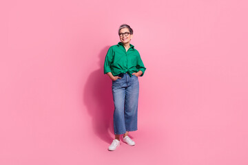 Full size photo of pretty retired female arms pockets look empty space wear trendy green outfit isolated on pink color background