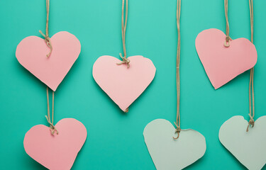 Pastel paper hearts on a teal background