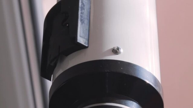 Close up, slow motion footage of the telescope on the window. Science