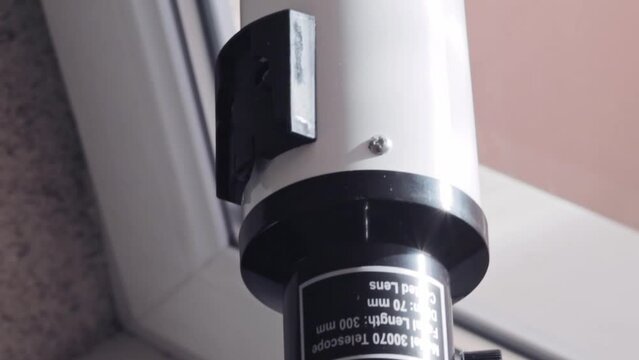 Close up, slow motion footage of the telescope on the window. Science
