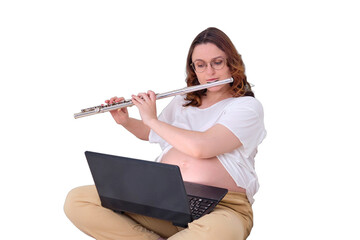 Pregnant woman on home bed playing classical music on big orchestral flute, isolated on a white background