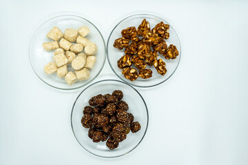 Three Plates Full of Sesame Ladoo, Til ko Laddu, Jaggery Peanuts Laddoo for Maghe Sankranti and Makar Sankranti Festival in Nepal and India