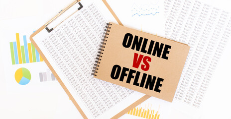 Text ONLINE VS OFFLINE on brown paper notepad on the table with diagram. Business concept