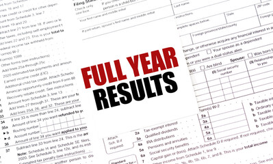 FULL YEAR RESULTS on white sticker with tax forms
