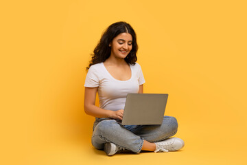 Smiling young indian woman enjoying newest educational course