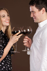 Young happy couple enjoying a glasses of wine