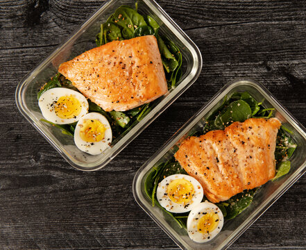 Meal prep with salmon, spinach and a hard boiled egg