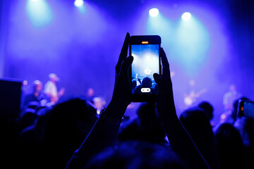 Youth Culture at Night: Audience Enjoying a Live Music Concert with Cellphones