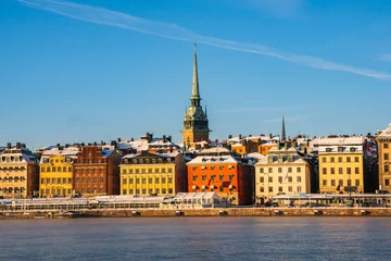 Foto op Canvas A cold sunny winter morning in Stockholm, with the historic buildings of the old town  (gamla stan) near the waterfront. German church spire © John