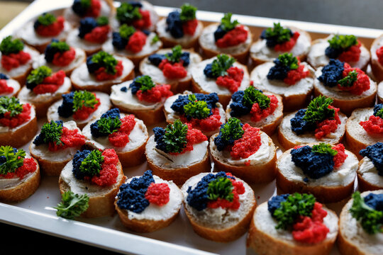 A Tray Of Delicious Hors D Oeuvres With Caviar And Salmon On Toasted Bread