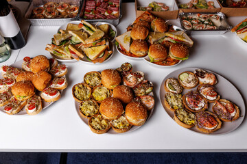 A delicious and diverse selection of appetizers and finger foods at a party, a catering event, or a buffet.