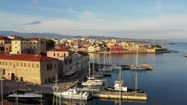 Chania with the amazing lighthouse, mosque, venetian shipyards, at sunset, Crete, Greece.