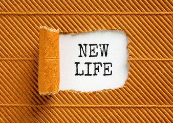 New life symbol. Concept words New life on wooden blocks on a beautiful white paper on a beautiful brown paper background. Business, support motivation psychological new life concept. Copy space.