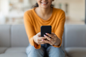 Closeup Shot Of Smiling Young Female Using Smartphone At Home