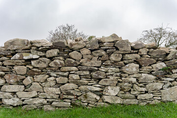 Lovely view of dry stone wall in rural area of Ireland perfectly placed gray tone and irregular...