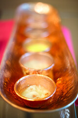 Copper tray with different scrubs and oils for spa procedures