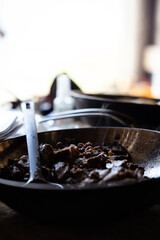 Campfire cooking of food in the nature while camping in summer