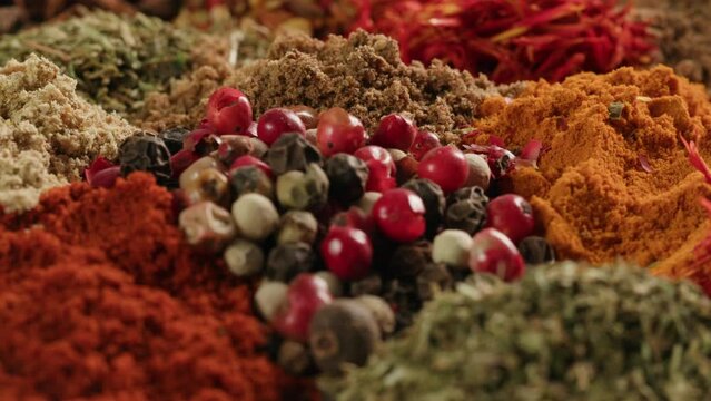 Mix spices dried pink, black pepper, green dill, red paprika, yellow turmeric, garlic, salt close-up macro. A bunch of natural spice for food .Seasonings and condiments concept