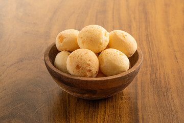 Cheese Breads bowl. Brazilian snack. Isolated on wooden background.